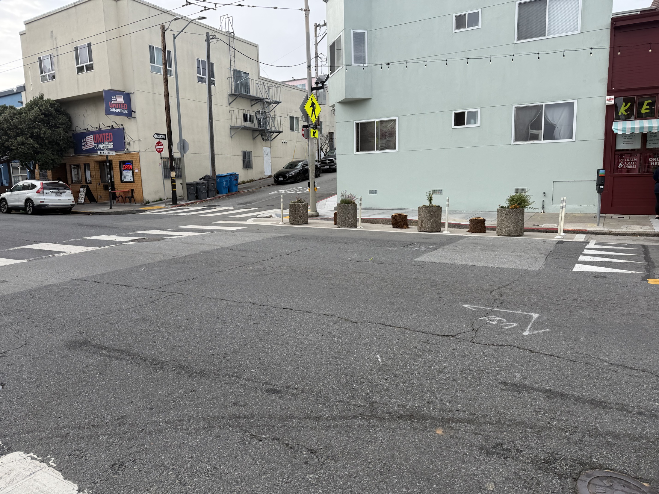 A wide view of planters placed within a soft-post-protected daylighting zone